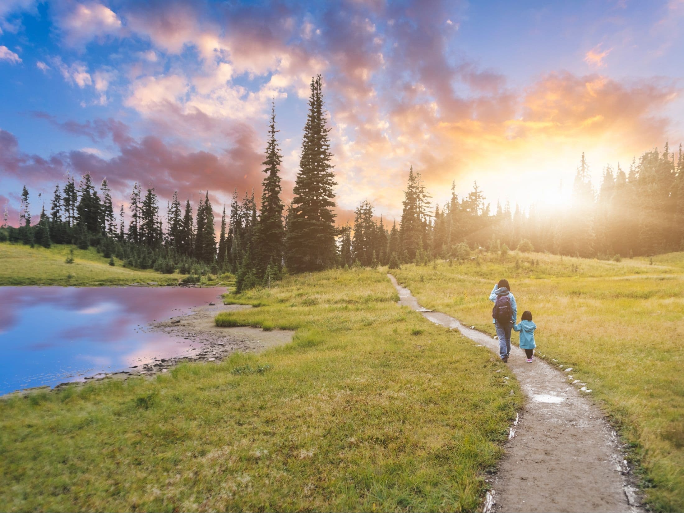 Woman and child hiking along trail